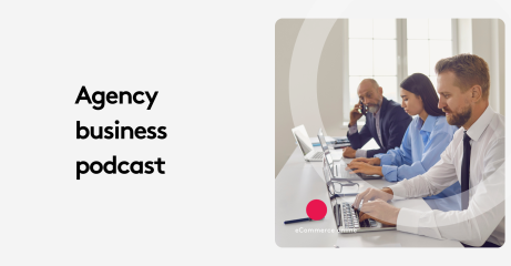 Team of three professionals working on laptops in an office setting.
