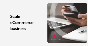Hands holding phone and credit card with laptop, scaling eCommerce business.