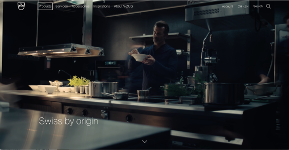 Chef cooking in a modern kitchen with Swiss branding visible