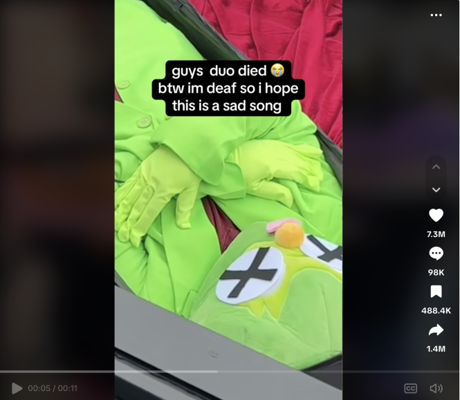 Green costume with crossed-out eyes and text overlay about a sad song.