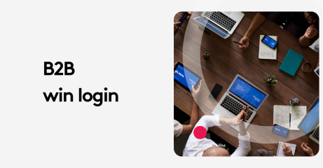 Top view of a business meeting with laptops, tablets, and notebooks on a wooden table.