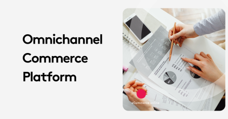 Two people reviewing business charts and graphs on a desk with a smartphone nearby.