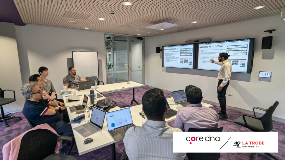 Group of people in a conference room watching a presentation on AI.