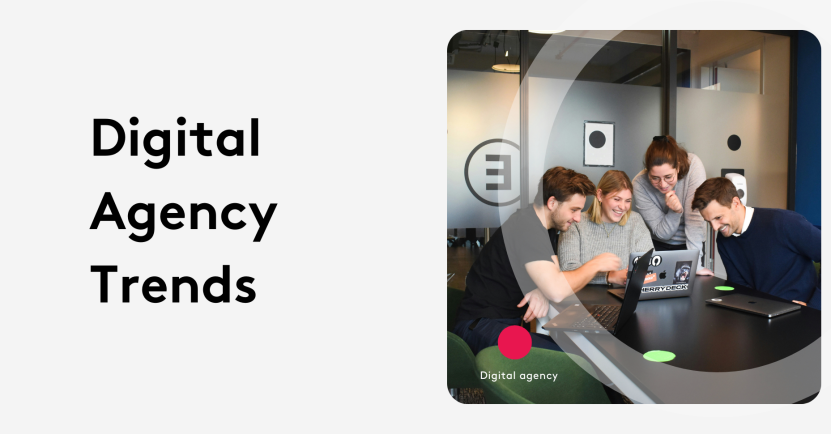 Team of four collaborating on laptops at a digital agency meeting.