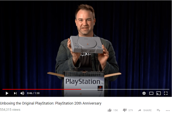 Person unboxing the original PlayStation for its 20th anniversary.