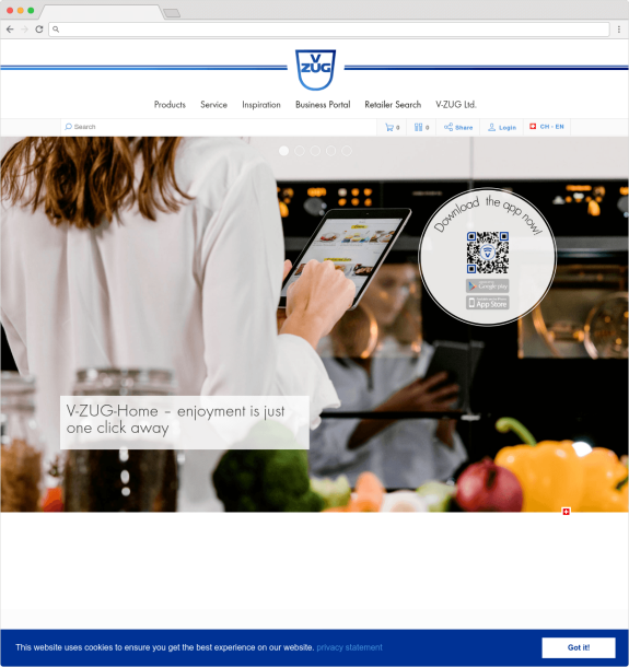 Person using a tablet in a kitchen setting with QR code for V-ZUG app download.