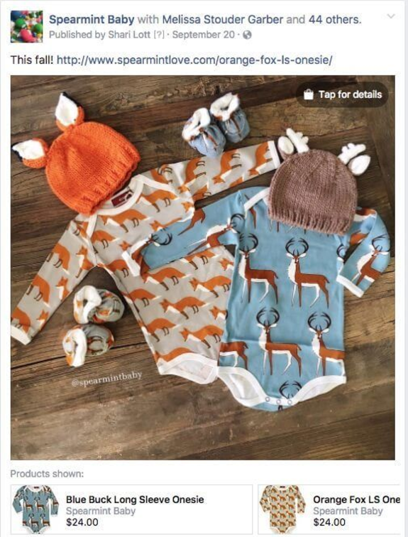 Two baby onesies with fox and buck patterns, matching hats and socks on wooden surface.