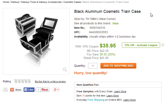 Black aluminum cosmetic train case open with compartments visible.