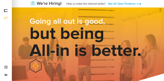 Motivational poster with team in background, text 'Going all out is good, but being All-in is better.'