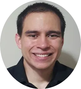 Smiling man in a black shirt against a plain background.