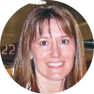 Smiling woman with brown hair in casual attire.