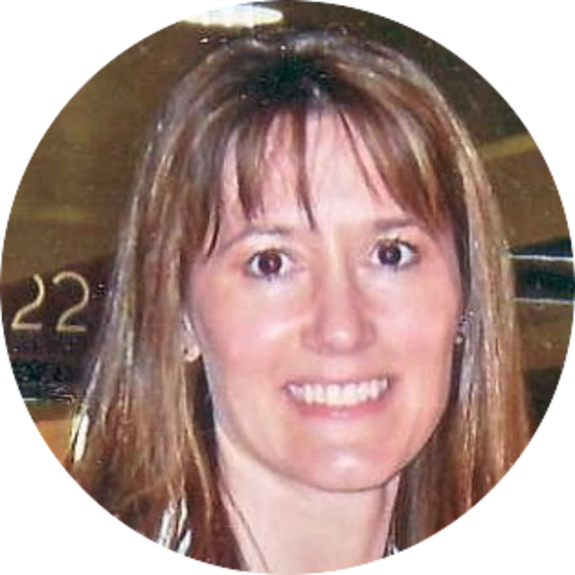 Smiling woman with brown hair in casual attire.