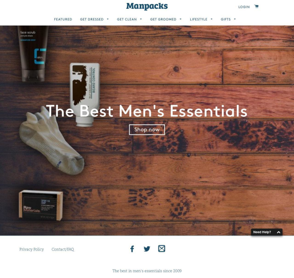 Men's essentials including face scrub and socks on wooden background.