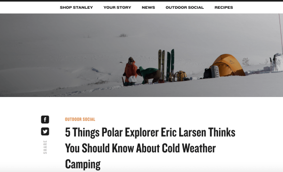 Polar explorer setting up camp in snowy landscape with tents and gear
