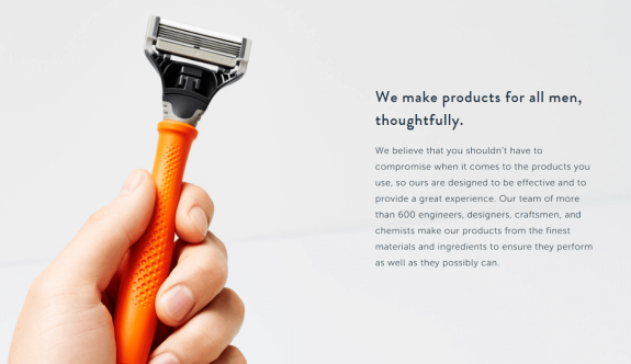 Hand holding an orange razor with text about thoughtful men's products.