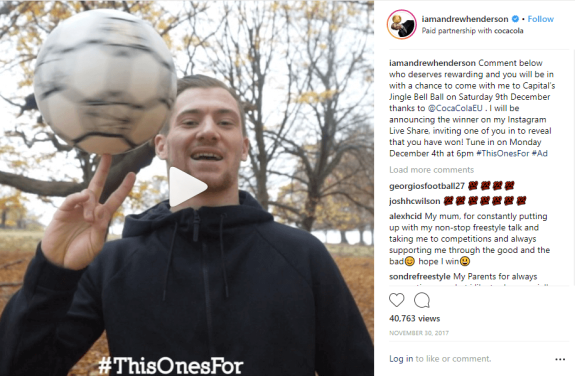 Man spinning a soccer ball on his finger in an autumn park.