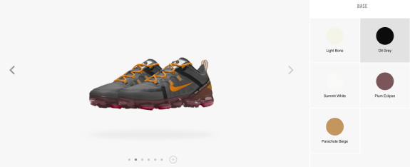 Nike Air VaporMax Plus sneakers in grey and orange with transparent sole.