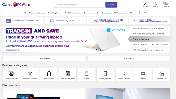 Currys PC World homepage with trade-in laptop offer banner and featured categories.
