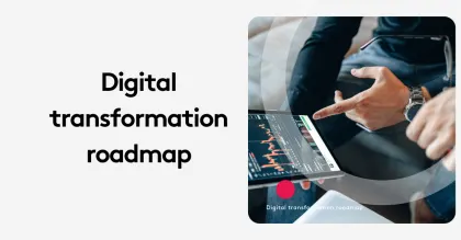 Two people discuss a digital transformation roadmap on a tablet displaying charts.