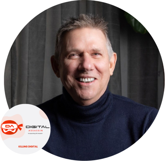 Smiling man in dark sweater with digital assassin logo in background