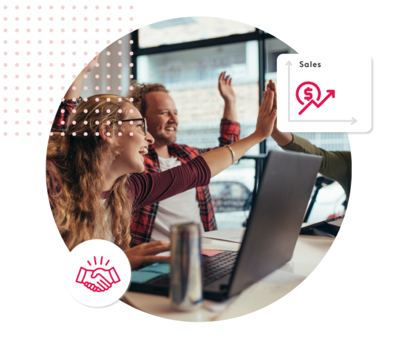 Team celebrating sales success with a high five in an office.