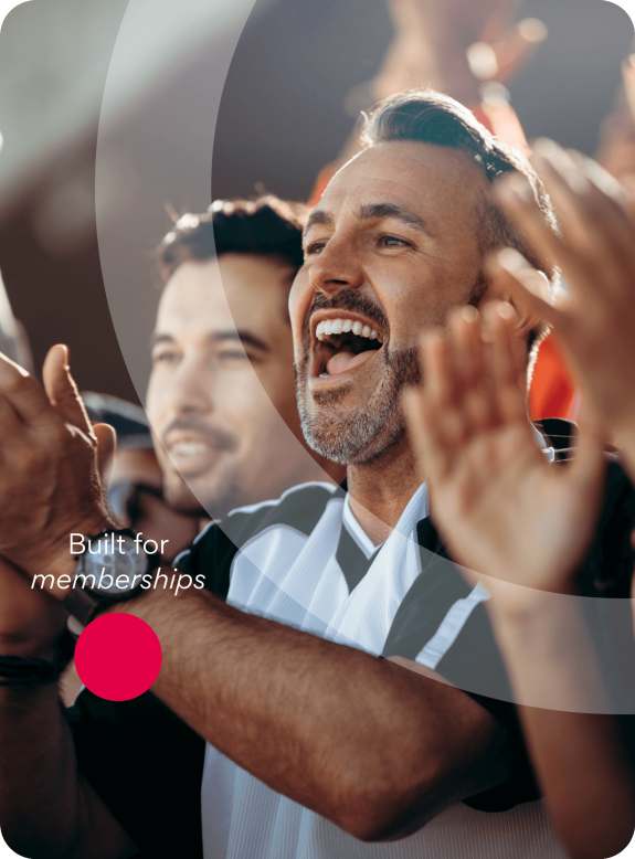 Cheering sports fans in a stadium with a focus on a middle-aged man.